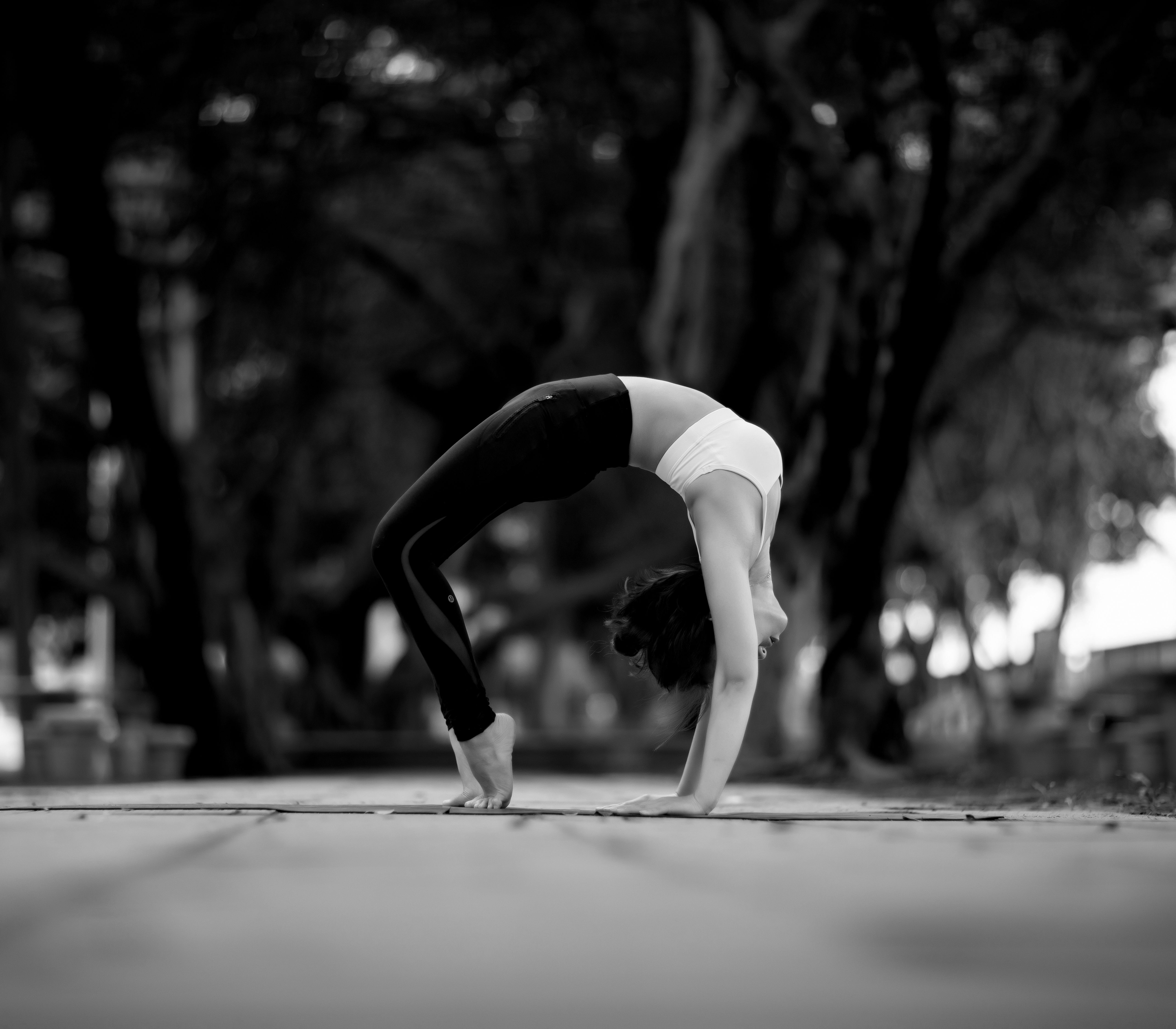 Yoga practitioner moving through a backbend outdoors